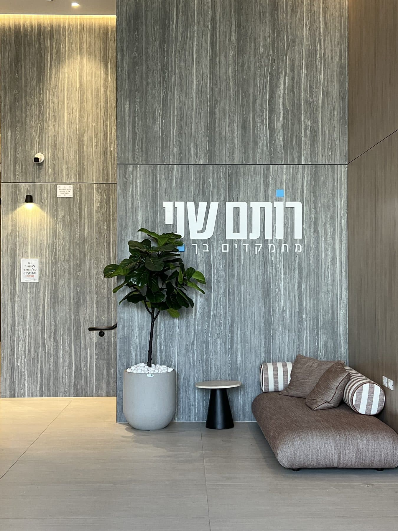 לובי הבניין עם מצלמת כיפה על הקיר ליד הדלת